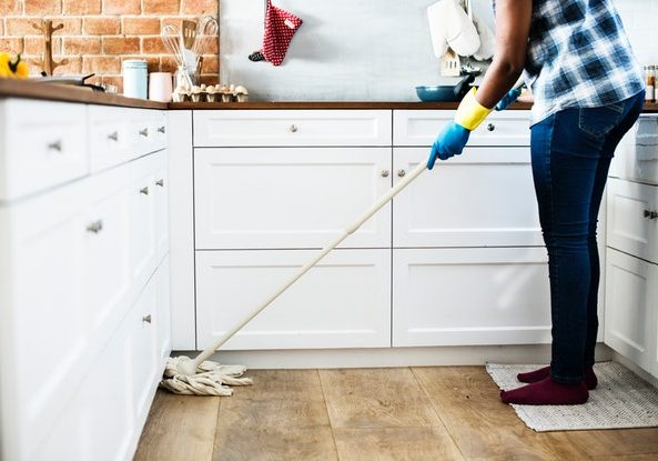 Woman mopping kitchen floor